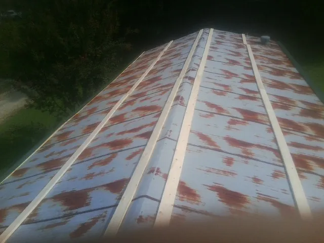Rusted metal roof panels with new wood purlins before replacement — Storm Damage Roof Repair in Amenia by Roofing Brothers